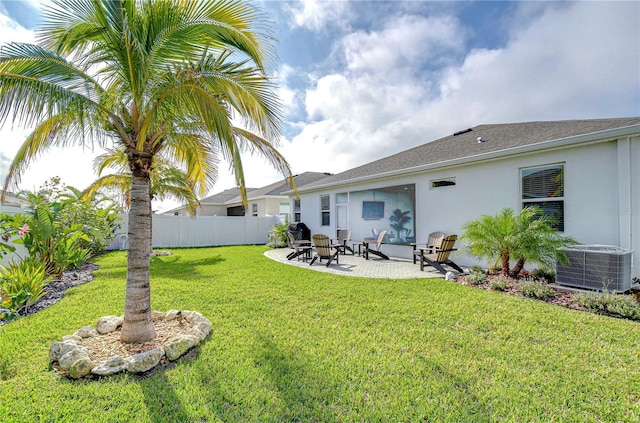 back of house featuring a yard, a patio, and central AC