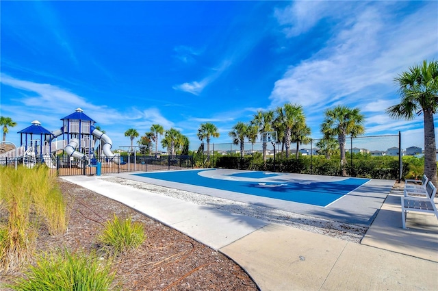 view of pool with a playground and basketball hoop