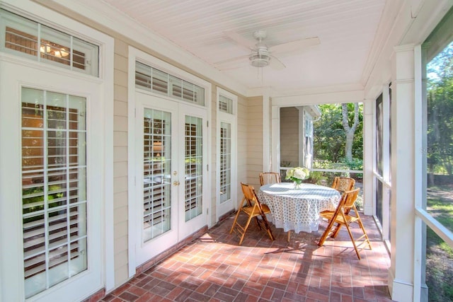 sunroom / solarium featuring ceiling fan, a wealth of natural light, and french doors