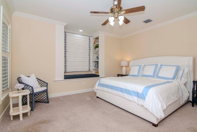 carpeted bedroom with ceiling fan and crown molding