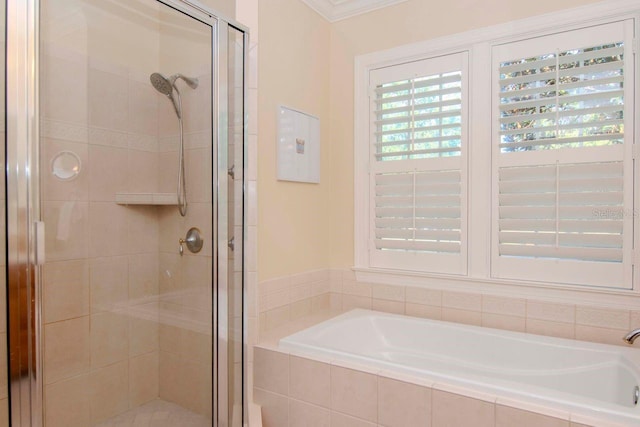 bathroom featuring independent shower and bath and ornamental molding