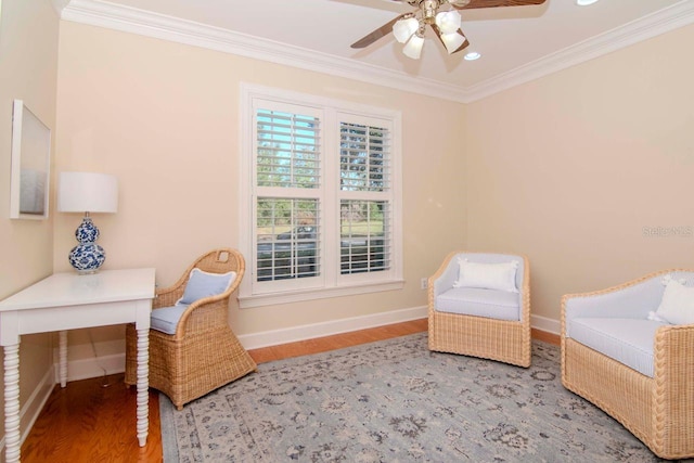 living area with ceiling fan, hardwood / wood-style floors, and ornamental molding