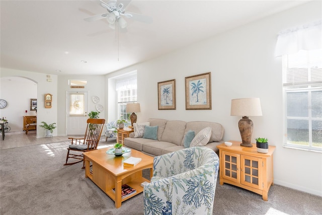 carpeted living room with ceiling fan