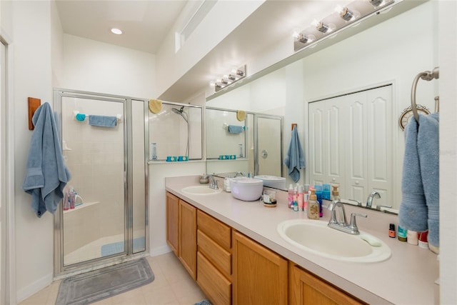 bathroom with tile patterned flooring, vanity, and walk in shower