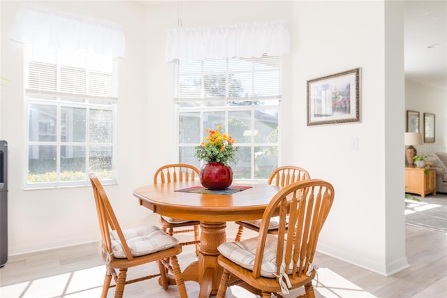 dining area featuring light hardwood / wood-style floors and plenty of natural light