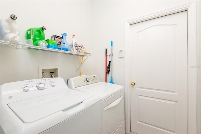 clothes washing area with washing machine and dryer