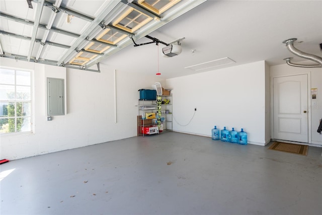 garage with a garage door opener and electric panel