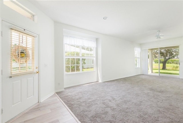 5733 Heronpark Pl, Lithia, FL 33547 - entrance foyer with a ceiling fan and light wood finished floors