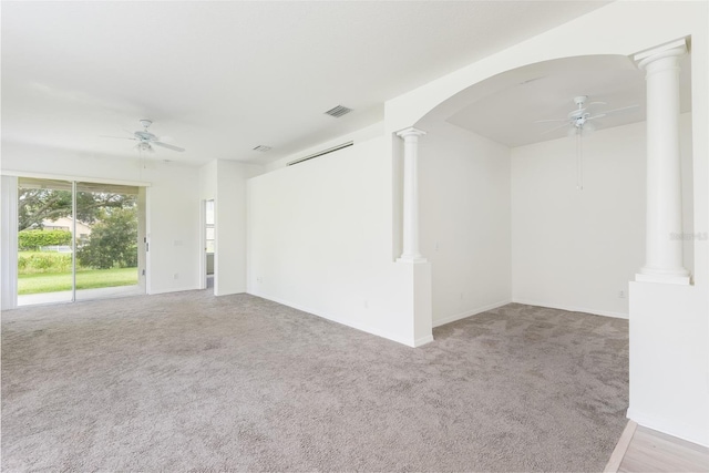5733 Heronpark Pl, Lithia, FL 33547 - carpeted spare room with ceiling fan, ornate columns, and arched walkways