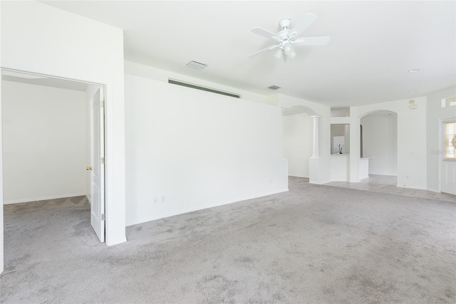 5733 Heronpark Pl, Lithia, FL 33547 - unfurnished living room with arched walkways, carpet flooring, and ceiling fan