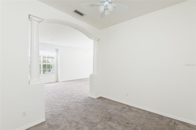 5733 Heronpark Pl, Lithia, FL 33547 - spare room featuring decorative columns, a ceiling fan, carpet, and arched walkways