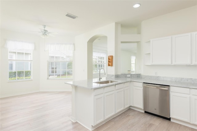 5733 Heronpark Pl, Lithia, FL 33547 - kitchen featuring stainless steel dishwasher, a peninsula, light wood finished floors, open shelves, and light stone countertops
