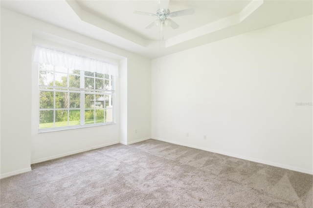 5733 Heronpark Pl, Lithia, FL 33547 - empty room with a tray ceiling, carpet floors, and ceiling fan