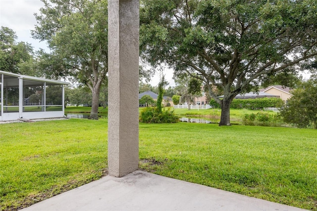 5733 Heronpark Pl, Lithia, FL 33547 - view of green lawn with a sunroom, a water view, and a patio area