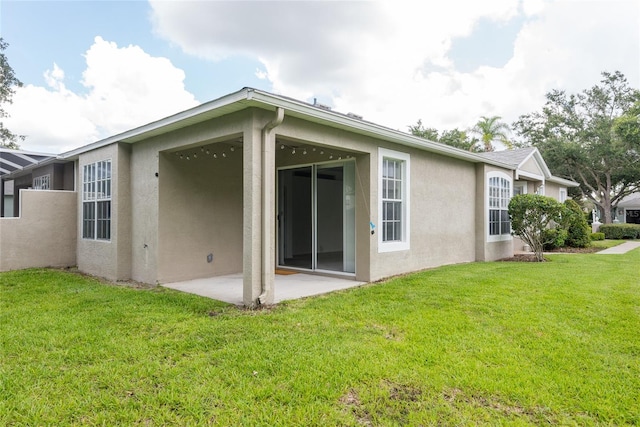 5733 Heronpark Pl, Lithia, FL 33547 - back of house featuring stucco siding, a patio area, and a yard