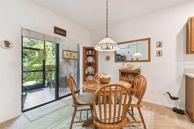 dining area with a notable chandelier and light carpet