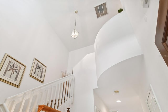 stairway featuring high vaulted ceiling