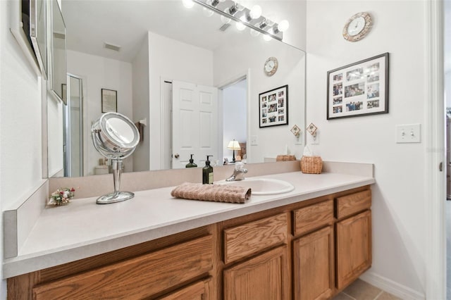 bathroom with tile patterned floors and vanity