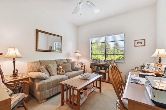 carpeted living room with ceiling fan