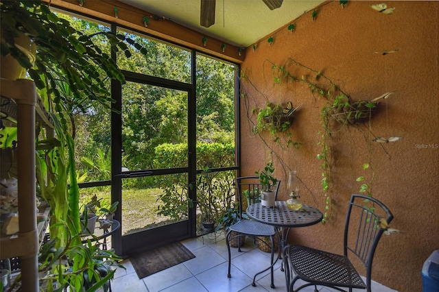 unfurnished sunroom featuring ceiling fan