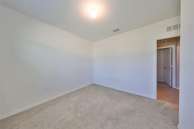 unfurnished room with light colored carpet