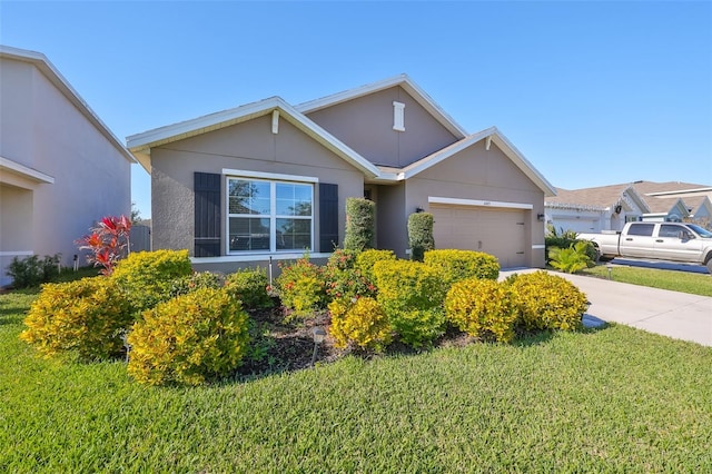 view of front of home with a garage and a front lawn