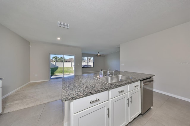 kitchen featuring ceiling fan, sink, dishwasher, a kitchen island with sink, and white cabinets