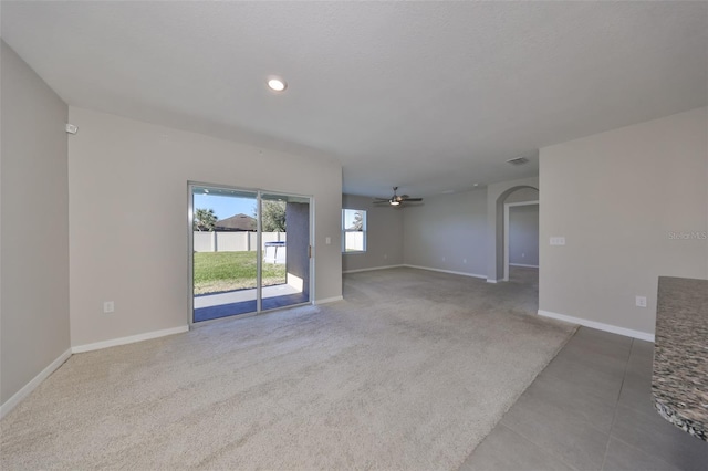 unfurnished room featuring ceiling fan and light colored carpet