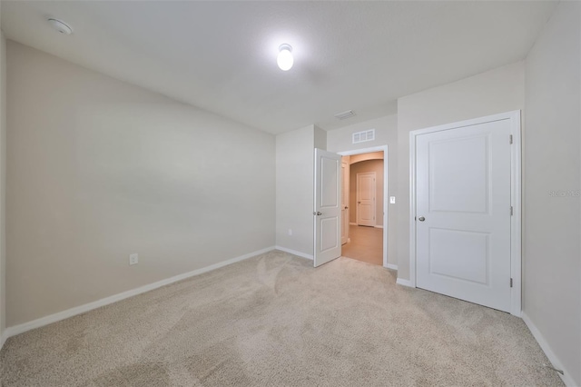 empty room with light colored carpet