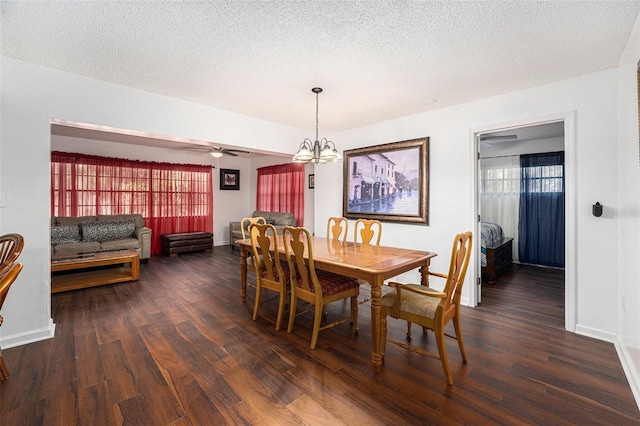 dining space with a textured ceiling and dark hardwood / wood-style floors