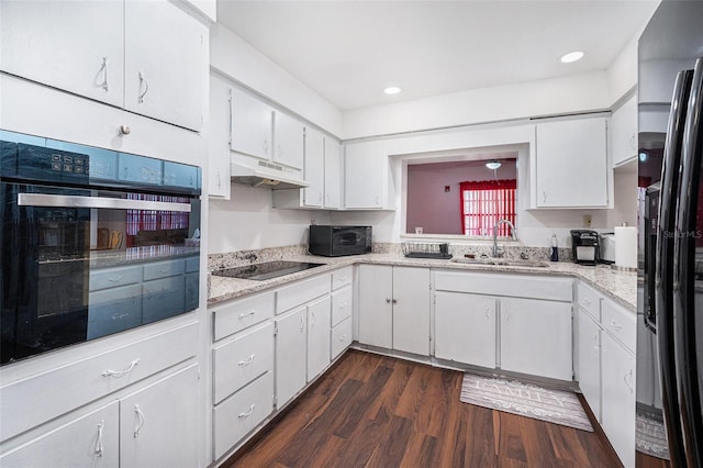 kitchen featuring dark hardwood / wood-style flooring, sink, white cabinets, and black appliances