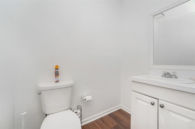 bathroom featuring hardwood / wood-style floors, vanity, and toilet