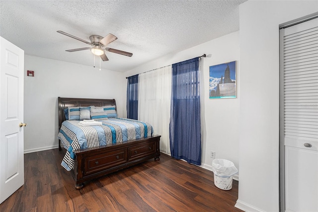 bedroom featuring a textured ceiling, ceiling fan, and dark wood-type flooring