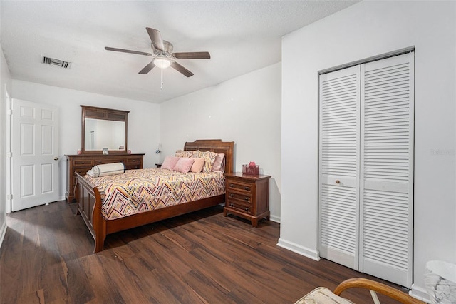 bedroom featuring a textured ceiling, a closet, ceiling fan, and dark wood-type flooring