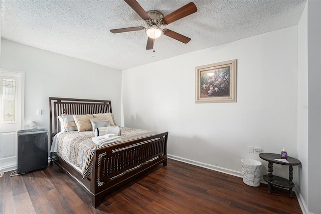 bedroom featuring a textured ceiling, ceiling fan, and dark hardwood / wood-style floors