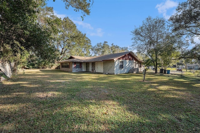 view of side of property with a yard