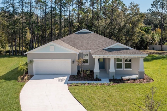 view of front of home with a front yard and a garage