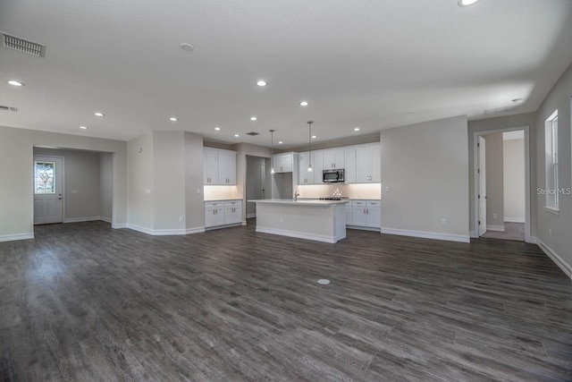 unfurnished living room with dark hardwood / wood-style flooring