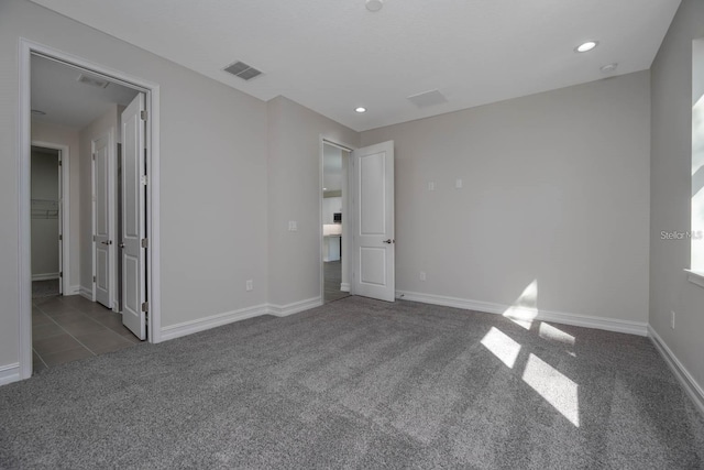 unfurnished bedroom featuring dark carpet