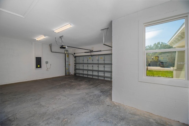 garage with electric panel and a garage door opener