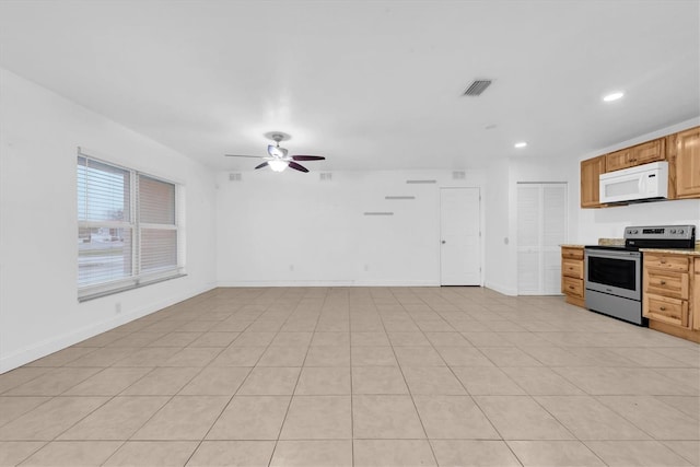 kitchen with electric stove, ceiling fan, and light tile patterned floors