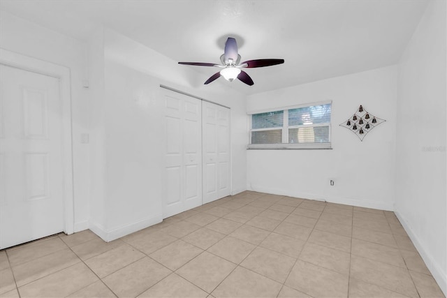 unfurnished room with ceiling fan and light tile patterned floors