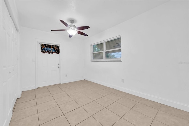 unfurnished room featuring ceiling fan and light tile patterned flooring