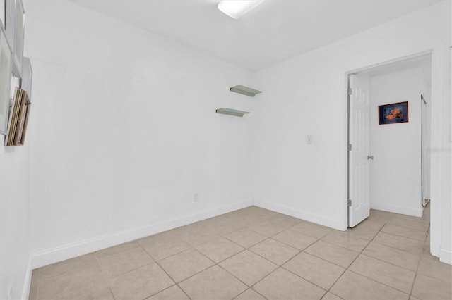 unfurnished room with light tile patterned flooring