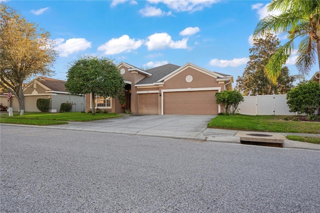 view of front of property with a front yard and a garage