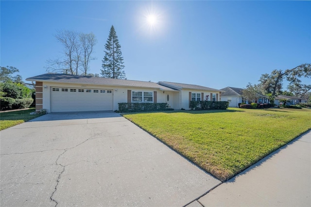 single story home with a garage and a front lawn