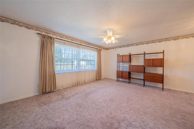 unfurnished room with light carpet, a textured ceiling, and ceiling fan