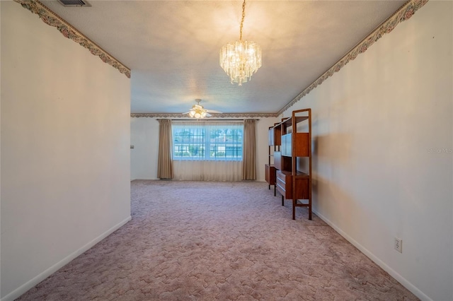 carpeted spare room with a textured ceiling and ceiling fan with notable chandelier