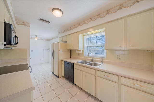 kitchen featuring ceiling fan, sink, tasteful backsplash, cream cabinetry, and black appliances