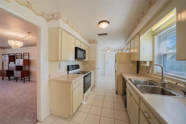 kitchen featuring dishwasher, sink, cream cabinetry, electric stove, and light carpet